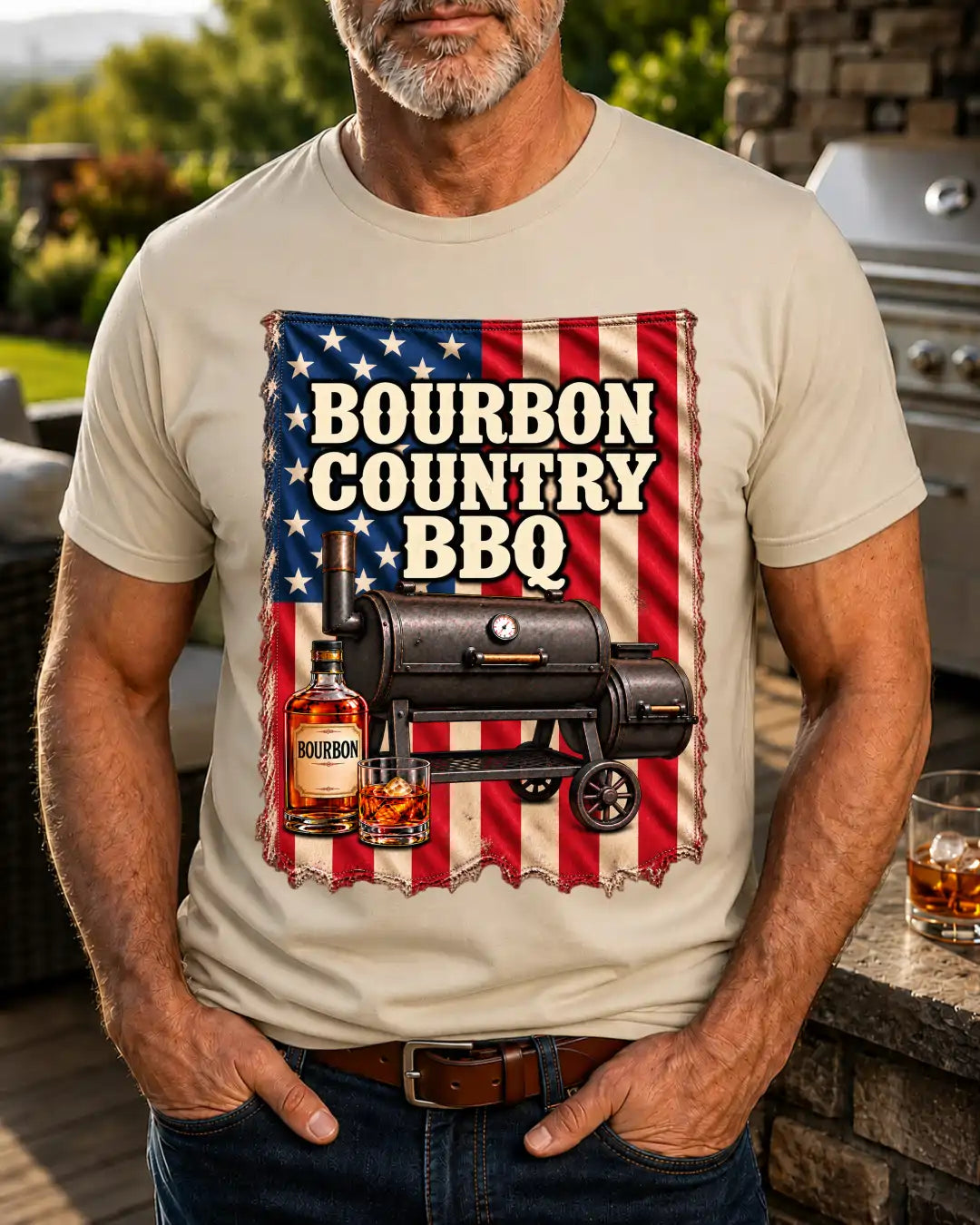 A man wearing a beige t-shirt with a graphic print that reads 'Bourbon Country BBQ' over an American flag background with a smoker and bourbon bottle, set in an outdoor patio environment.