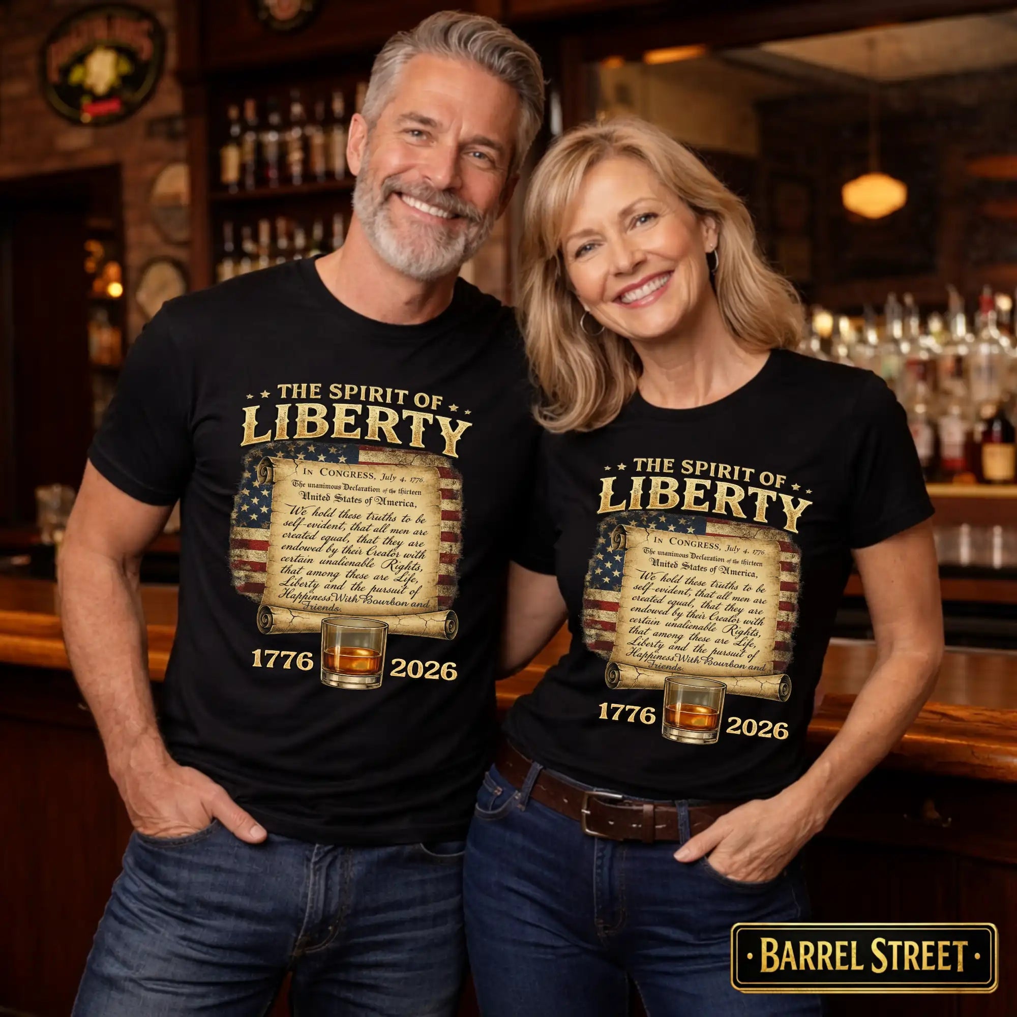 Man and woman wearing 'The Spirit of Liberty' t-shirts in a bar setting.