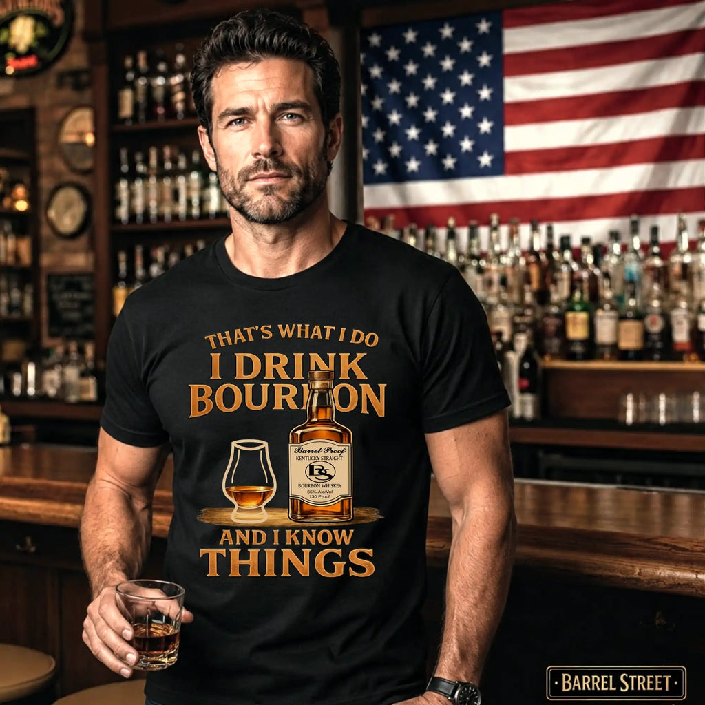 Man wearing a t-shirt with a bourbon-themed design in a bar setting.