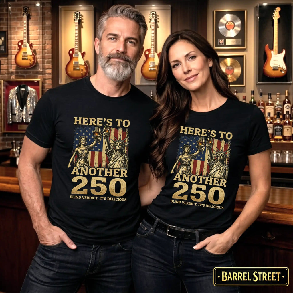 Two people wearing matching black t-shirts with a graphic design and text, standing in a bar setting.