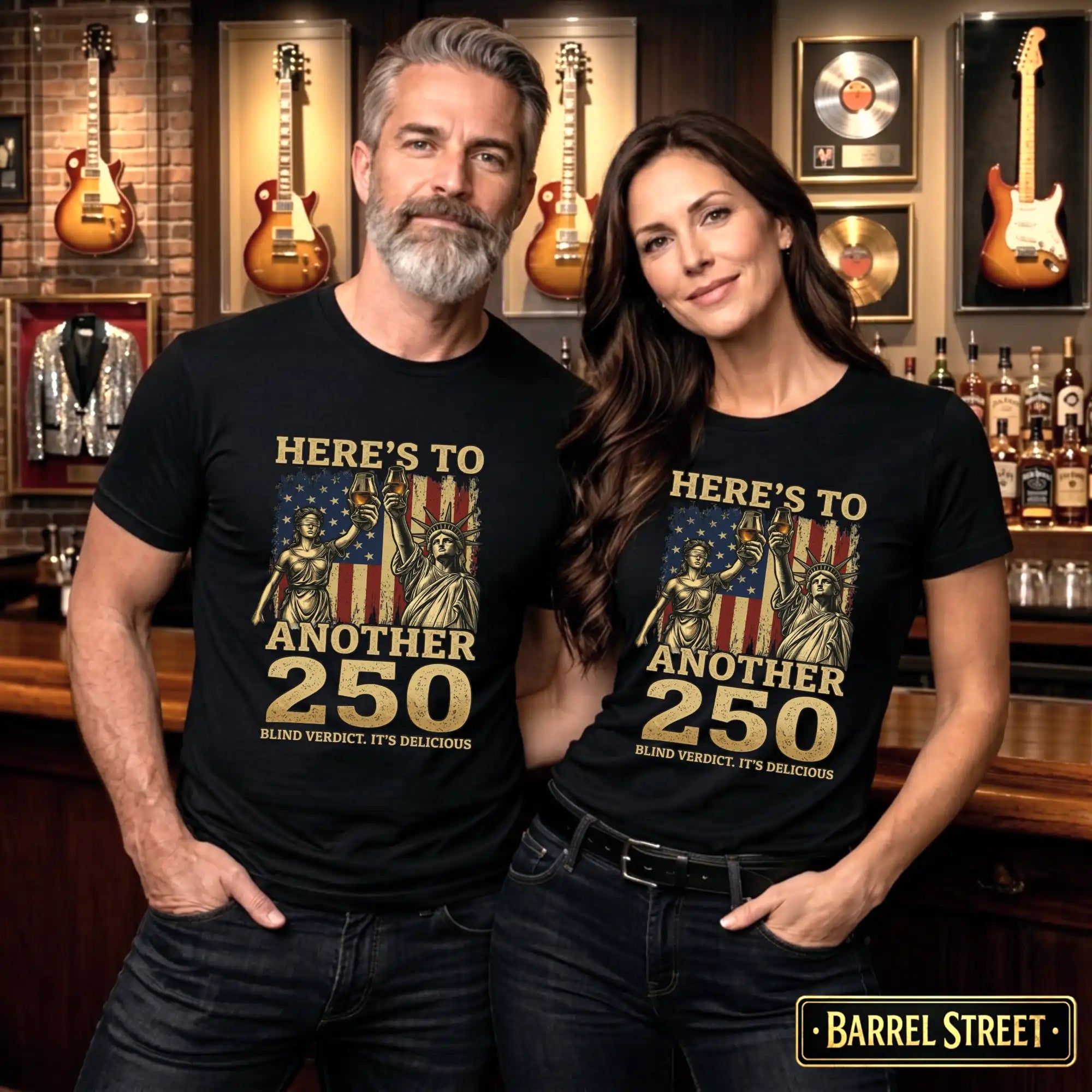 Two people wearing matching black t-shirts with a graphic design and text, standing in a bar setting.