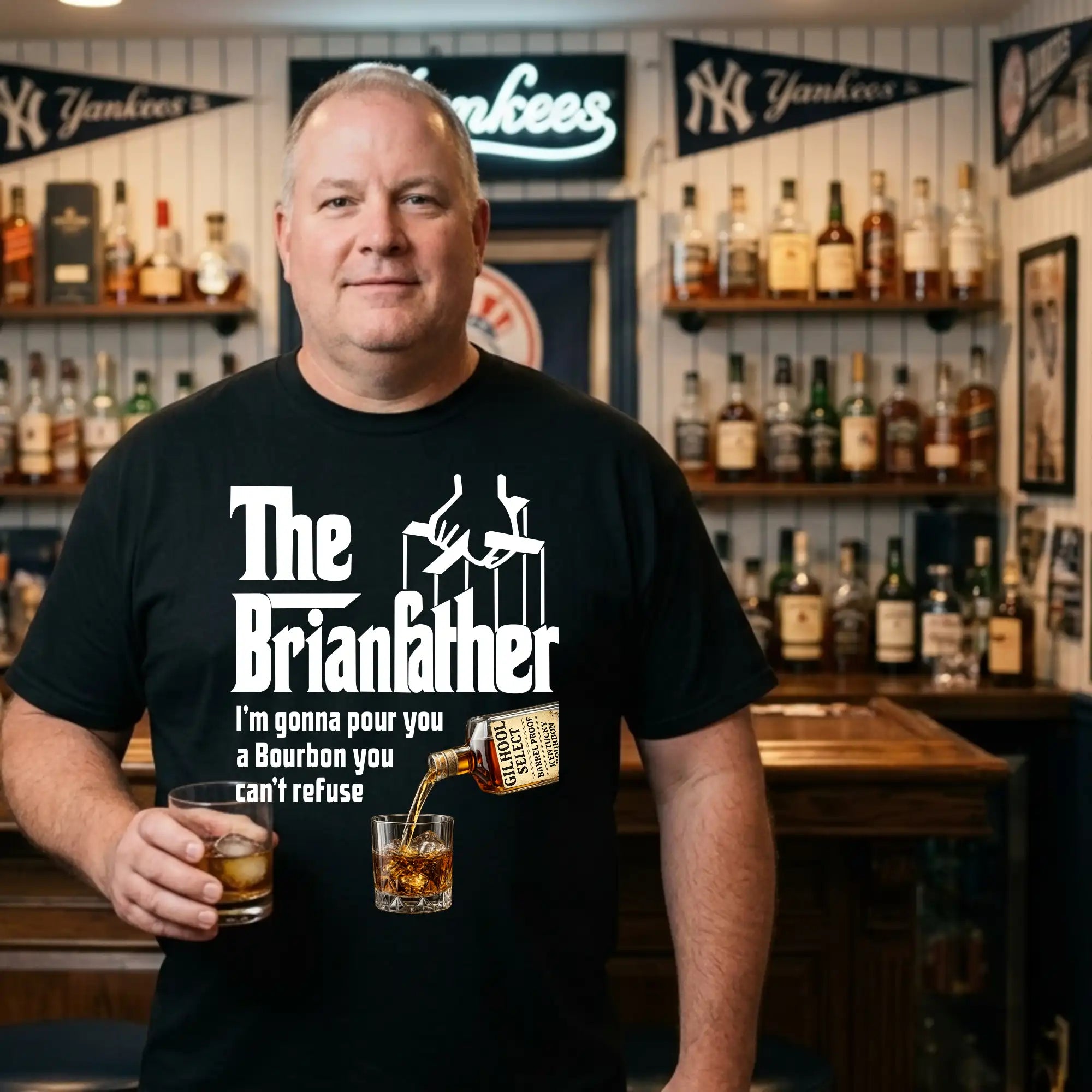 Man wearing a black t-shirt with 'The Brianfather' design, standing in a bar with shelves of bottles.