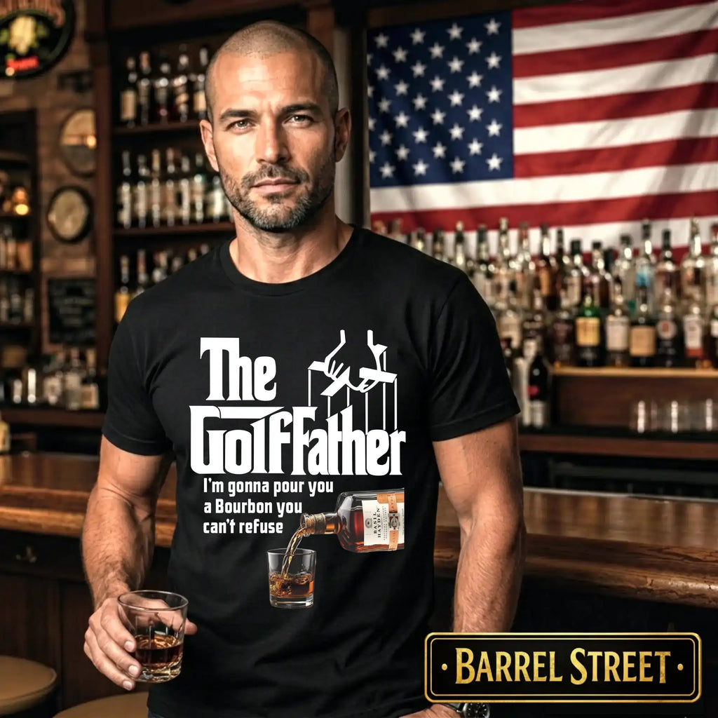 Man wearing a black t-shirt with 'The Golffather' design in a bar setting with an American flag in the background.