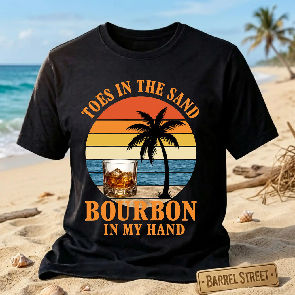 Black t-shirt with 'Toes in the Sand, Bourbon in My Hand' design on a beach background