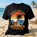 Black t-shirt with 'Toes in the Sand, Bourbon in My Hand' design on a beach background