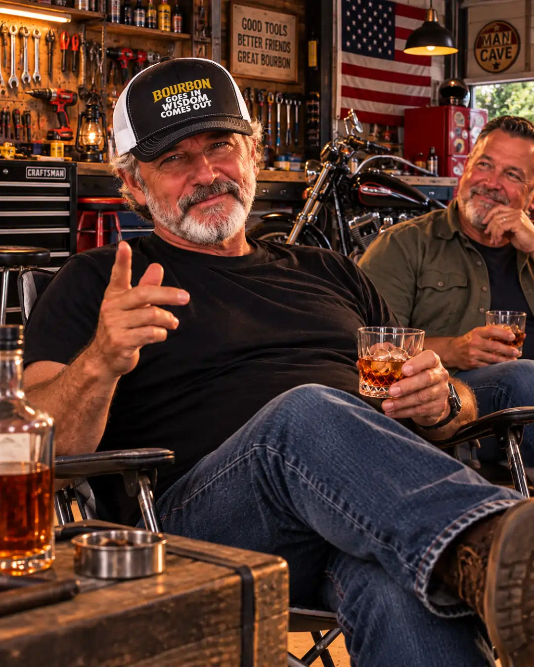 A black and white trucker cap with the text 'BOURBON GOES IN WISDOM COMES OUT' in yellow and white on the front, bourbon hat