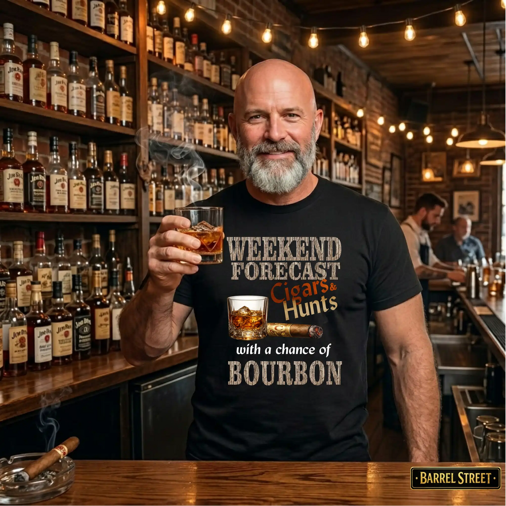 Man holding a glass of whiskey in a bar setting with shelves of liquor behind him.